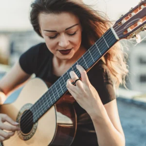 Women playing on guitar and wearing silicone ring